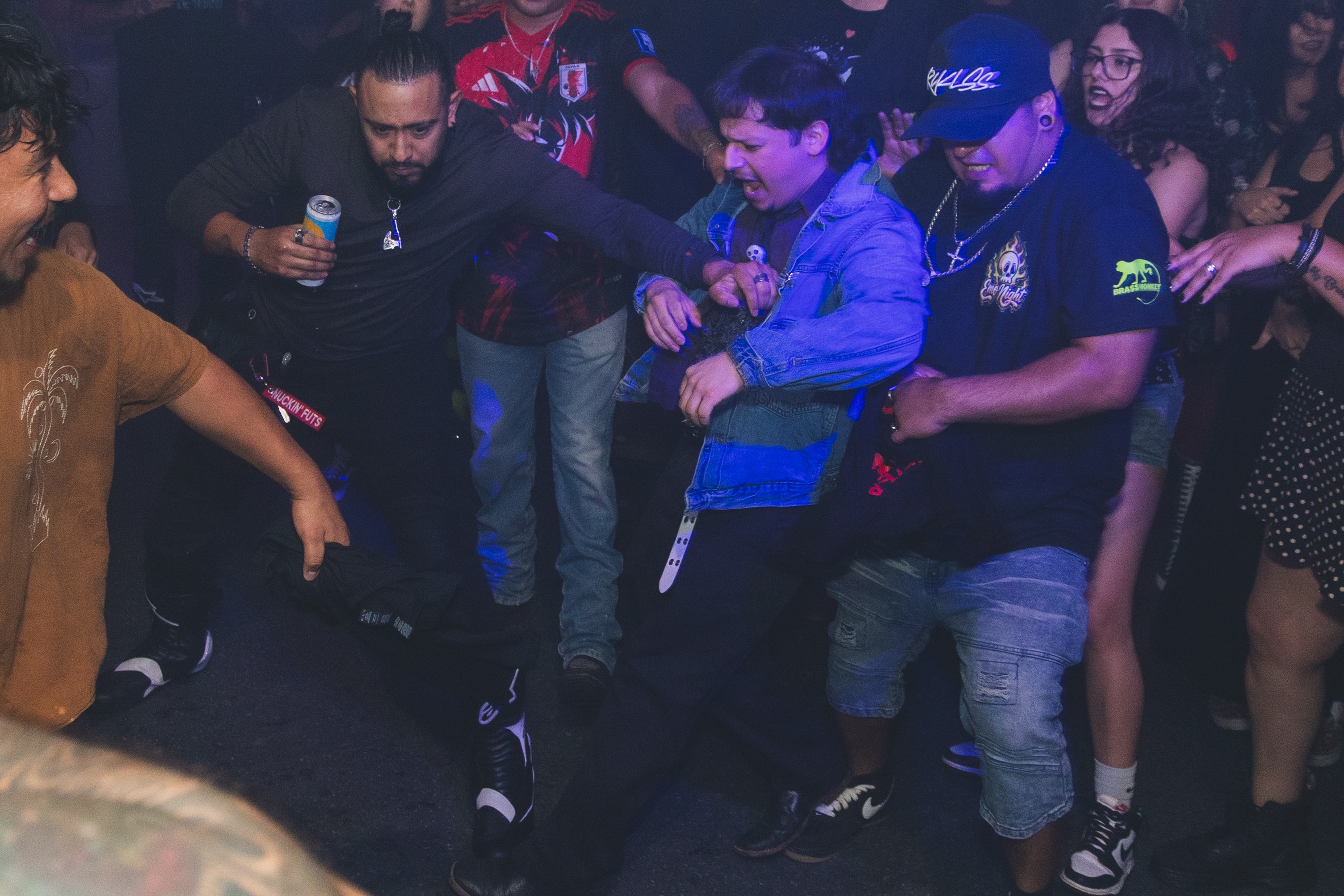 Group moshing under blue lights at SATX Emo Club