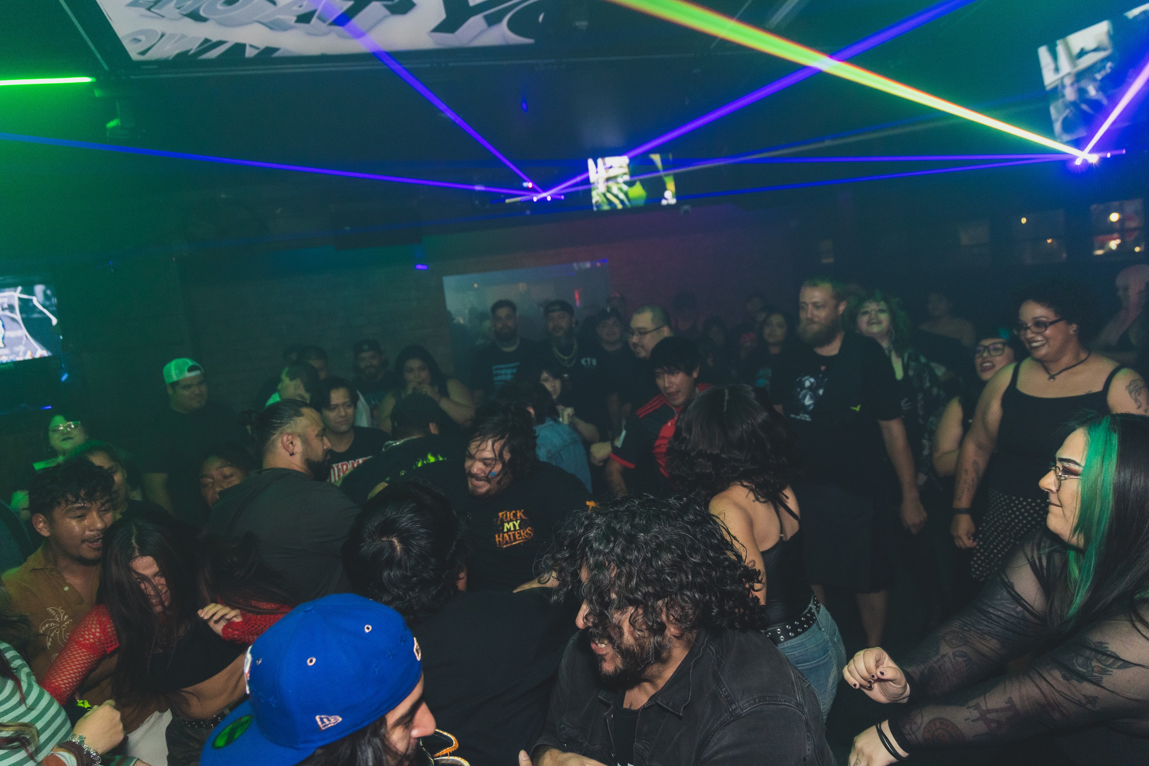 Full dance floor crowd under laser light show at SATX Emo Club