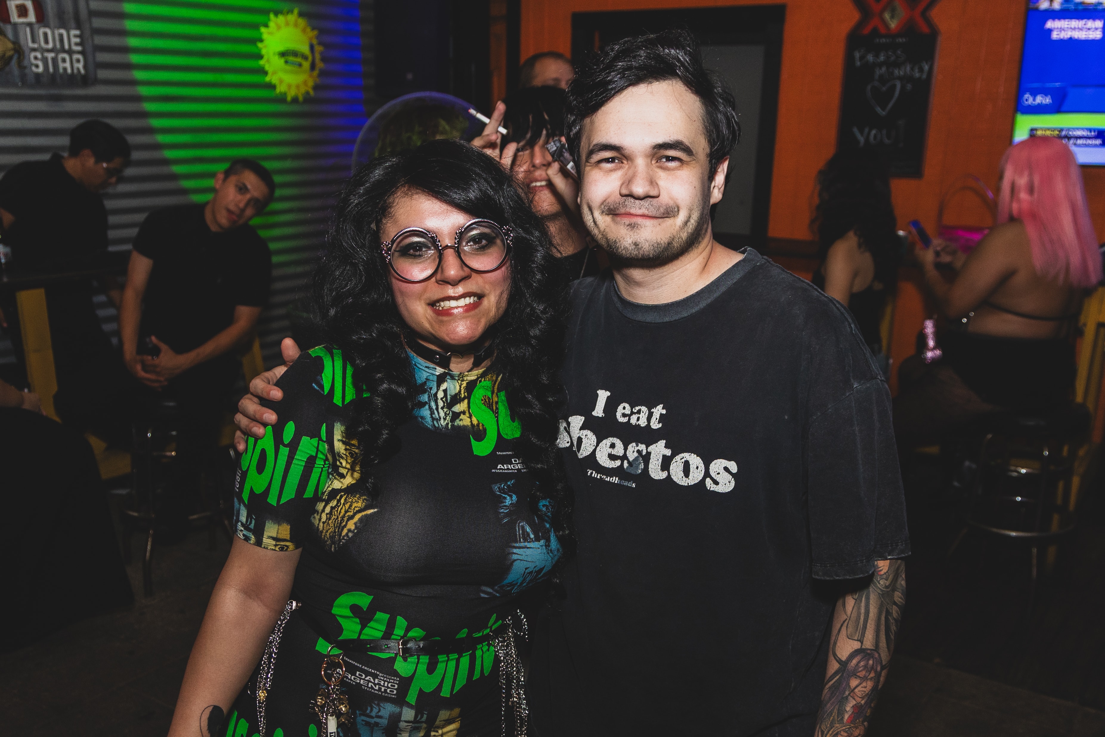 Couple posing at SATX Emo Club with neon lighting