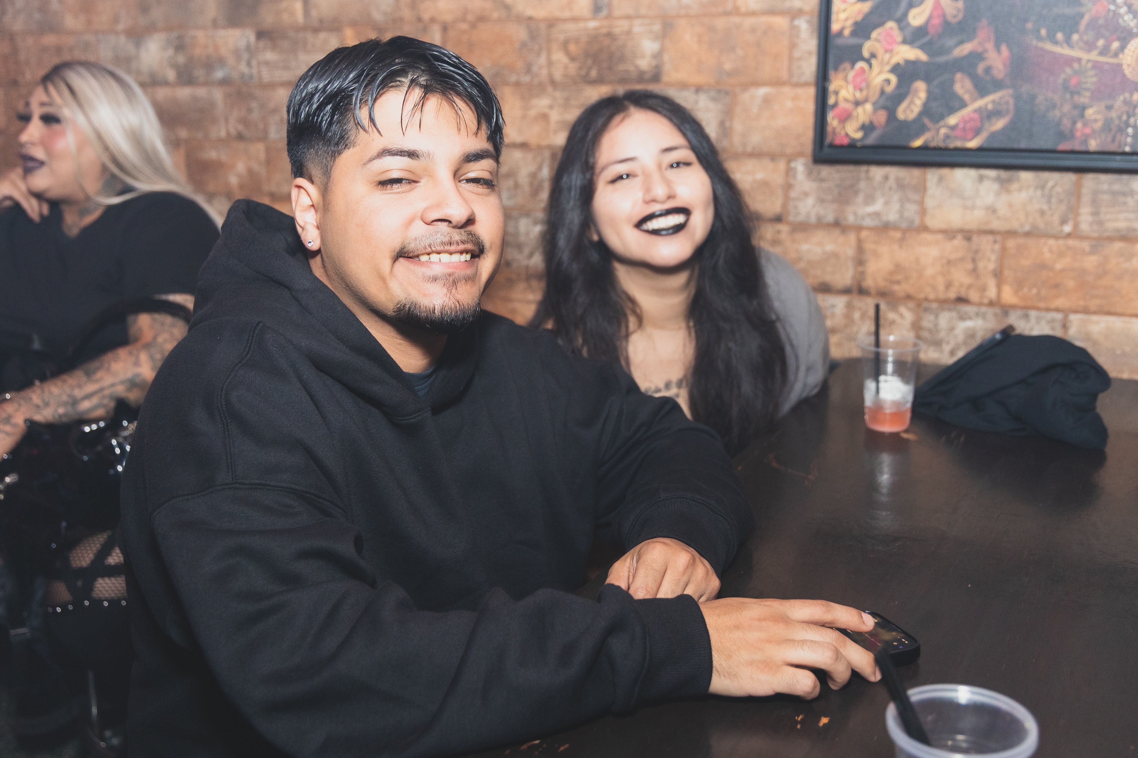 Couple smiling at bar counter at SATX Emo Club
