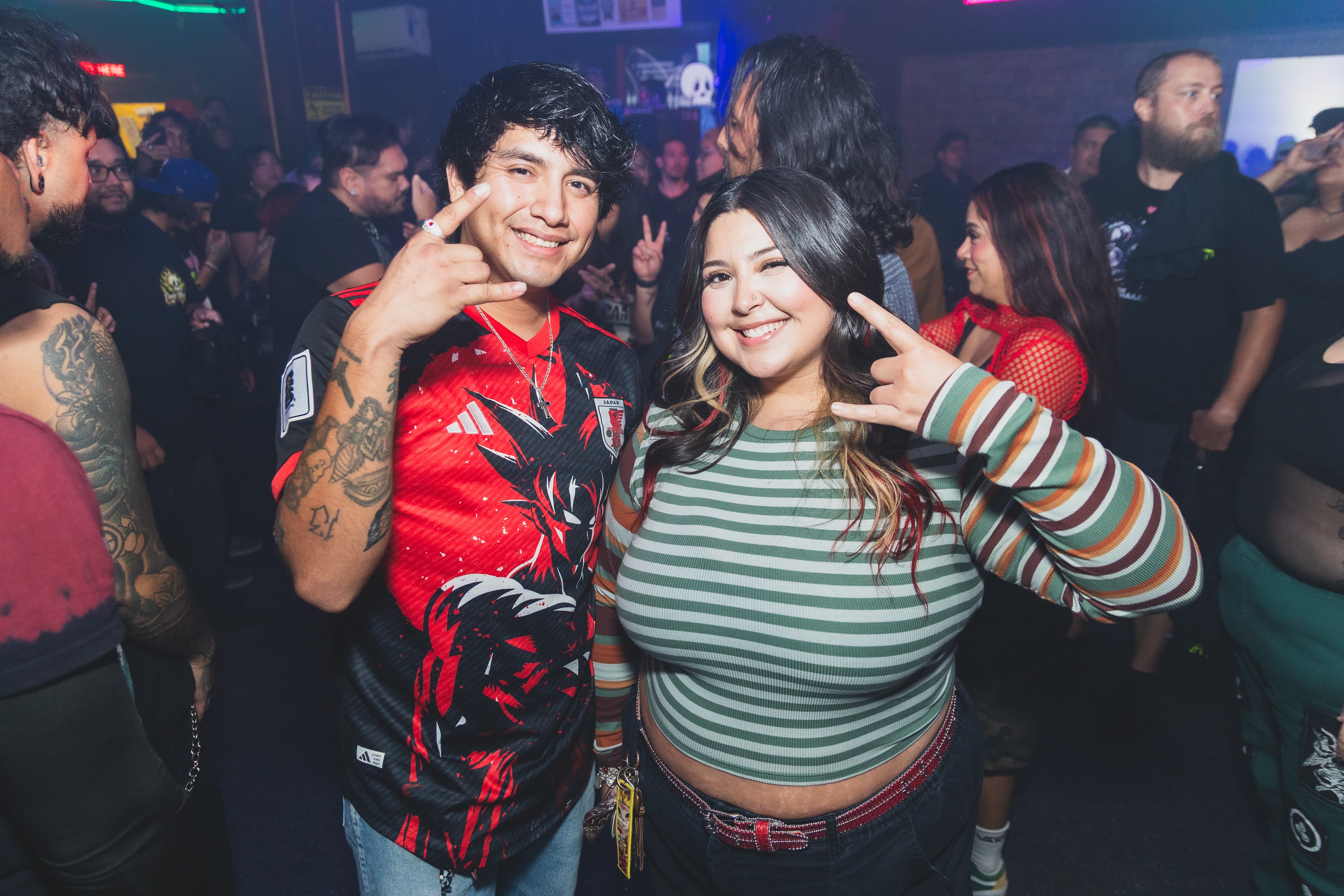Two friends posing with peace signs at SATX Emo Club