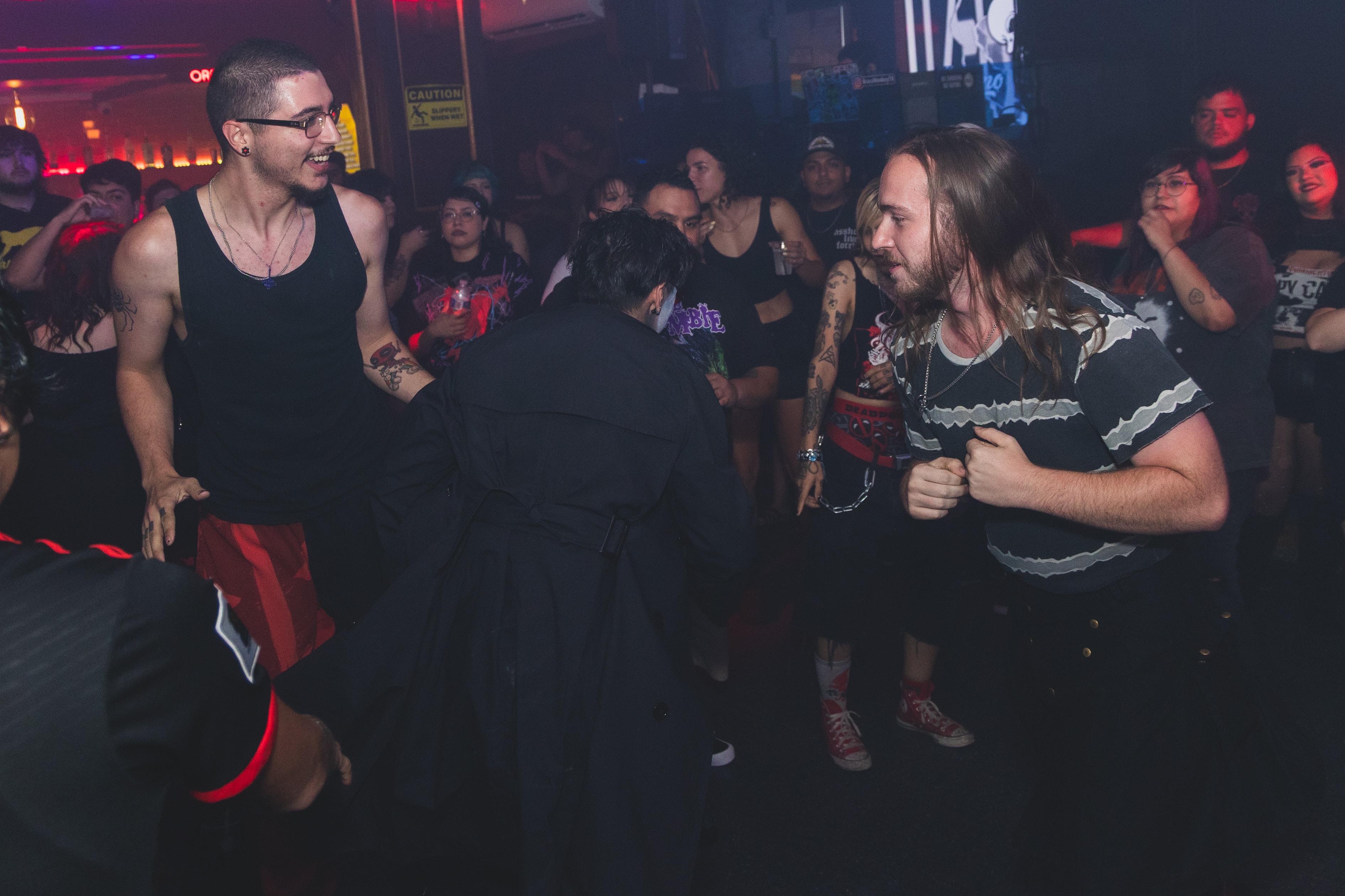 Two guys squaring up in the mosh pit circle at SATX Emo Club