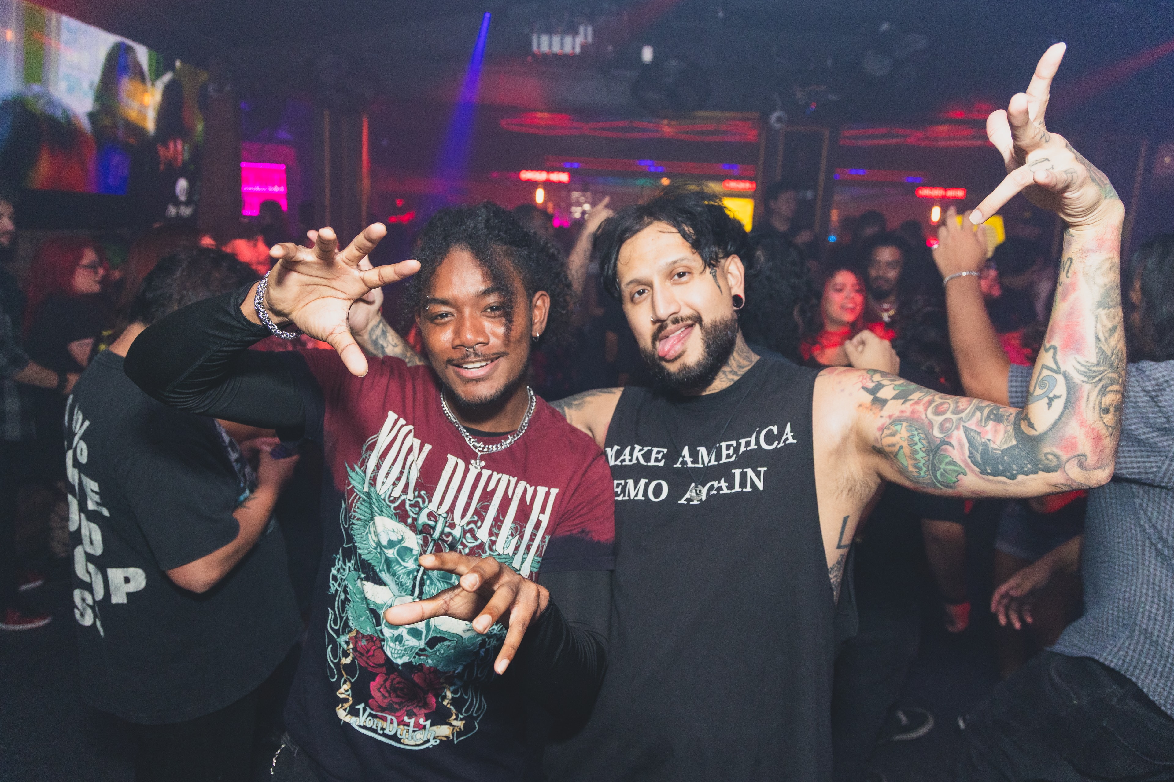 Von Dutch tee and Make America Emo Again tank top duo posing with hands up at SATX Emo Club